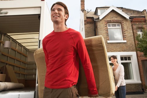 Commercial movers handling desks and equipment during an office move